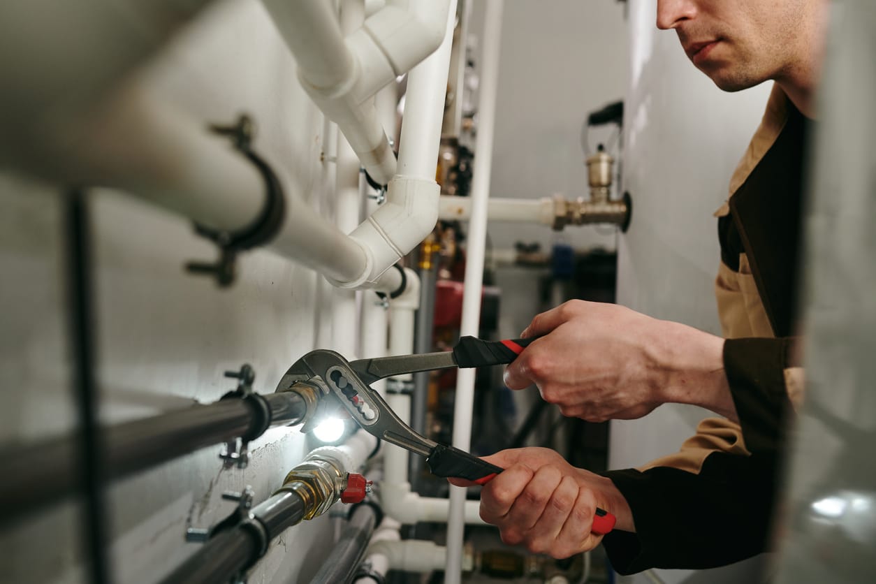 Plumbers maintaining commercial plumbing pipes in Jurupa Valley
