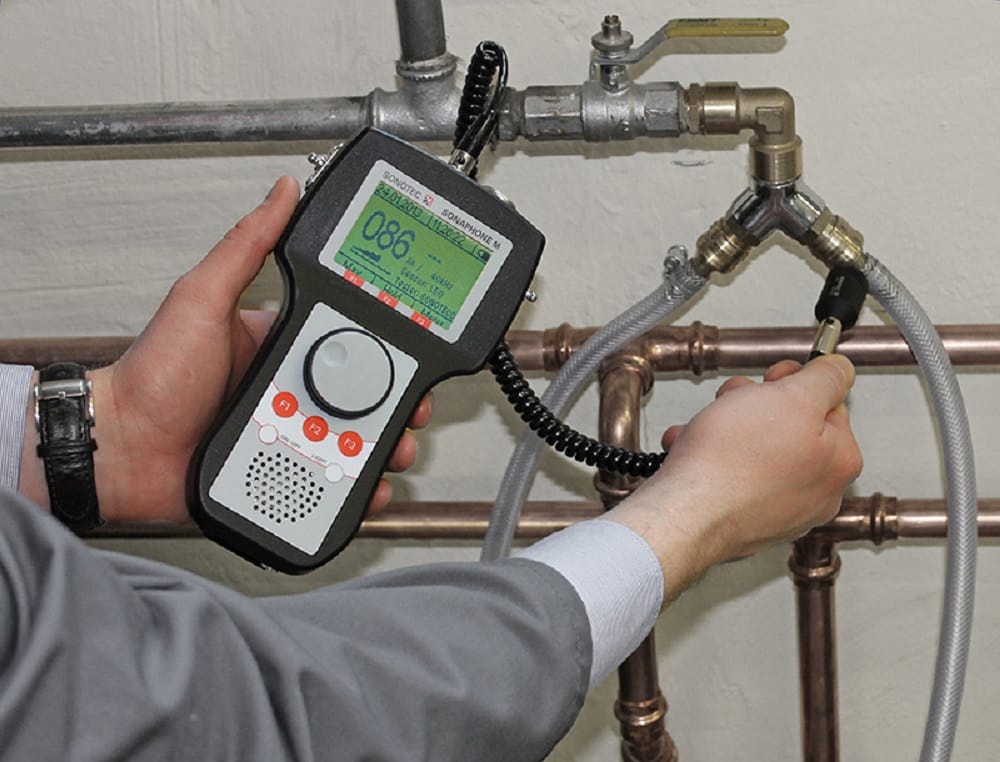 Plumber testing pipes with electronic leak detection equipment in Jurupa Valley