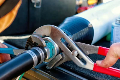 Technician tightening an industrial pipe connection in Jurupa Valley