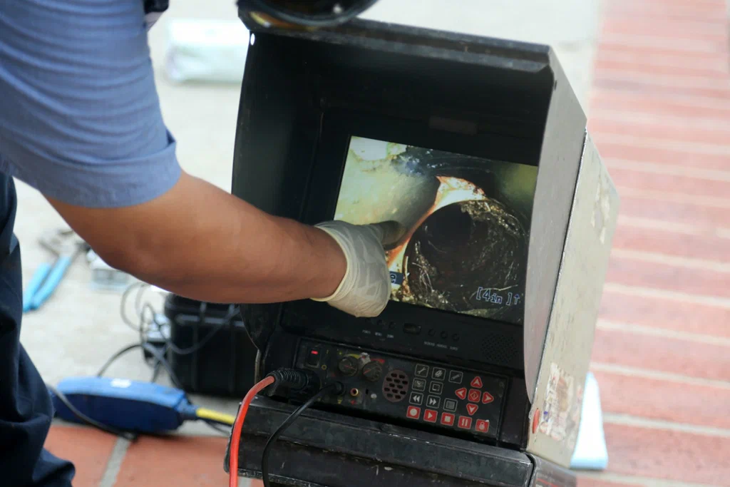Technician viewing a drain inspection camera in Jurupa Valley