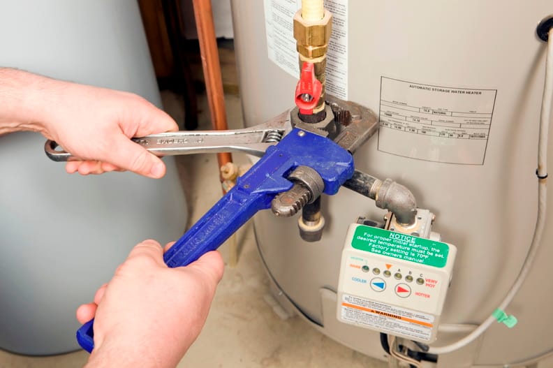 Plumber repairing a water heater valve in Jurupa Valley
